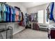 Large walk-in closet offering ample storage with double hanging rods and room for luggage at 11203 N Northfield St, Surprise, AZ 85388