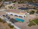 Aerial view of the house with a large backyard including a pool, basketball court, and putting green at 11225 E Starflower Ct, Chandler, AZ 85249