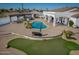 Backyard paradise boasting a pool, outdoor kitchen, putting green, and ample patio space at 11225 E Starflower Ct, Chandler, AZ 85249