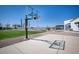 Relaxing backyard with a sports court, putting green and covered patio for entertaining at 11225 E Starflower Ct, Chandler, AZ 85249