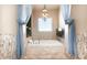 Luxurious bathroom featuring a soaking tub, decorative lighting, and tile surround at 11225 E Starflower Ct, Chandler, AZ 85249