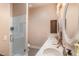 A well-lit bathroom with double sinks, granite countertops and a glass-enclosed shower at 11225 E Starflower Ct, Chandler, AZ 85249