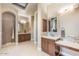 Elegant bathroom with double vanities, tile flooring, modern lighting, and walk-in shower at 11225 E Starflower Ct, Chandler, AZ 85249