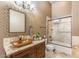 Stylish bathroom with granite countertop, vessel sink, decorative mirror, and tiled shower at 11225 E Starflower Ct, Chandler, AZ 85249
