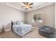 A comfortable bedroom featuring a tray ceiling, ceiling fan, and neutral decor at 11225 E Starflower Ct, Chandler, AZ 85249