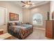 Cozy bedroom with carpet flooring, ceiling fan, and large window, filled with natural light at 11225 E Starflower Ct, Chandler, AZ 85249