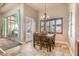 Cozy dining area features a chandelier, and natural lighting, and sliding glass doors to the pool at 11225 E Starflower Ct, Chandler, AZ 85249