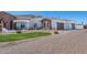 Charming single-story home featuring a beautiful brick driveway, three-car garage, and inviting front porch at 11225 E Starflower Ct, Chandler, AZ 85249