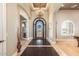 Grand foyer featuring a decorative iron door, chandelier, and tile flooring at 11225 E Starflower Ct, Chandler, AZ 85249