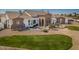 Elegant home featuring a stone facade, decorative fountain, manicured lawn, and desert landscaping at 11225 E Starflower Ct, Chandler, AZ 85249