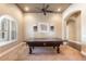 Entertain in this game room with shuttered windows and pool table at 11225 E Starflower Ct, Chandler, AZ 85249