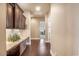 Hallway with wood floors, granite countertops, white cabinets, and recessed lighting at 11225 E Starflower Ct, Chandler, AZ 85249