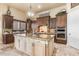 Spacious kitchen featuring a large island, custom cabinetry, granite countertops, and modern appliances at 11225 E Starflower Ct, Chandler, AZ 85249