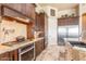 Well-equipped kitchen with stainless steel appliances, stone backsplash, custom cabinets, and tile floors at 11225 E Starflower Ct, Chandler, AZ 85249