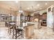 Spacious eat-in kitchen with dual islands, granite countertops, custom cabinets, and designer chandeliers at 11225 E Starflower Ct, Chandler, AZ 85249