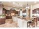 Bright kitchen featuring dual islands, custom cabinets, granite countertops, and stainless steel appliances at 11225 E Starflower Ct, Chandler, AZ 85249