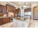 Gourmet kitchen showcasing custom wood cabinets, granite countertops, stainless steel appliances, and tiled flooring at 11225 E Starflower Ct, Chandler, AZ 85249