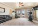 Bright living room with access to the pool, plush leather sofa and exercise equipment at 11225 E Starflower Ct, Chandler, AZ 85249