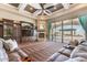 Relax in this living room with tray ceilings, media center, and fireplace overlooking the pool at 11225 E Starflower Ct, Chandler, AZ 85249