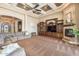 Entertain in this living room with tray ceilings, fireplace, and media center at 11225 E Starflower Ct, Chandler, AZ 85249