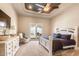 Relax in this main bedroom with backyard access, a ceiling fan, and neutral color palette at 11225 E Starflower Ct, Chandler, AZ 85249