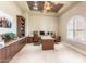Home office with dual workstations, custom cabinets, and natural light at 11225 E Starflower Ct, Chandler, AZ 85249