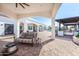 Spacious outdoor patio with stylish seating, an outdoor kitchen, and a pergola at 11225 E Starflower Ct, Chandler, AZ 85249