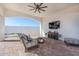 Covered patio space with comfortable seating, ceiling fan, and outdoor television at 11225 E Starflower Ct, Chandler, AZ 85249
