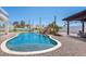 Beautiful pool and backyard featuring a rock waterfall, lush greenery, and comfortable outdoor seating at 11225 E Starflower Ct, Chandler, AZ 85249