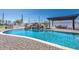 Inviting pool with rock waterfall feature, surrounded by a patio and lush landscaping at 11225 E Starflower Ct, Chandler, AZ 85249