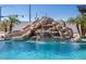 Close up of a pool with a rock waterfall and slide, perfect for outdoor fun at 11225 E Starflower Ct, Chandler, AZ 85249