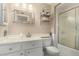 Cozy bathroom with a white vanity, a sink, and a shower featuring a sliding glass door at 13226 N Cedar Dr, Sun City, AZ 85351