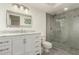 Updated bathroom features white vanity with marble countertop and shower with modern tile and glass door at 13226 N Cedar Dr, Sun City, AZ 85351