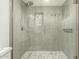 Elegant bathroom features a glass-enclosed shower, modern fixtures, and stylish tile at 13226 N Cedar Dr, Sun City, AZ 85351