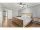 Spacious bedroom features hardwood floors, large bed, and ensuite bathroom at 13226 N Cedar Dr, Sun City, AZ 85351