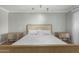 Bedroom with hardwood floors, large bed, and ensuite bathroom at 13226 N Cedar Dr, Sun City, AZ 85351