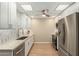 Open kitchen with stainless steel appliances and bright white cabinets at 13226 N Cedar Dr, Sun City, AZ 85351