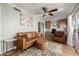 Cozy living room with a plush leather sofa, stylish ottoman, and patio access at 13226 N Cedar Dr, Sun City, AZ 85351