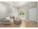 Bright living room with wood floors, neutral walls, and comfortable seating area at 13226 N Cedar Dr, Sun City, AZ 85351