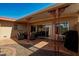 Covered patio area with outdoor seating and a grill, creating a cozy space for relaxation and gatherings at 13226 N Cedar Dr, Sun City, AZ 85351