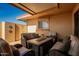Relaxing covered patio with comfortable seating around a table, ideal for enjoying outdoor living at 13226 N Cedar Dr, Sun City, AZ 85351