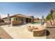 Expansive backyard oasis boasts a pool, built-in BBQ, and a cozy fire pit with seating for entertaining at 14302 W Laurel Ln, Surprise, AZ 85379