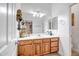 Bathroom features a white countertop vanity with decorative accents and double mirrors at 14302 W Laurel Ln, Surprise, AZ 85379