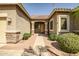 Inviting front entry showcasing desert landscaping, a tiled walkway, and a covered porch at 14302 W Laurel Ln, Surprise, AZ 85379