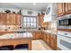 Well-appointed kitchen with granite countertops, wood cabinets, and modern stainless-steel appliances at 14302 W Laurel Ln, Surprise, AZ 85379