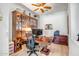 Office space with built-in shelving, wood floors, and a large desk area at 14302 W Laurel Ln, Surprise, AZ 85379