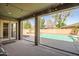 Covered patio offers seamless indoor-outdoor living with views of the sparkling pool and landscaped backyard at 14302 W Laurel Ln, Surprise, AZ 85379