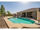 Resort-style pool area features a built-in BBQ, ample seating, and lush landscaping for ultimate relaxation at 14302 W Laurel Ln, Surprise, AZ 85379