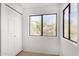 Bright bedroom with tile floors, closet, and two windows at 15225 N 100Th St # 2210, Scottsdale, AZ 85260