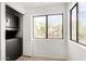 Bright laundry room with tile floors, windows, and stacked washer/dryer at 15225 N 100Th St # 2210, Scottsdale, AZ 85260